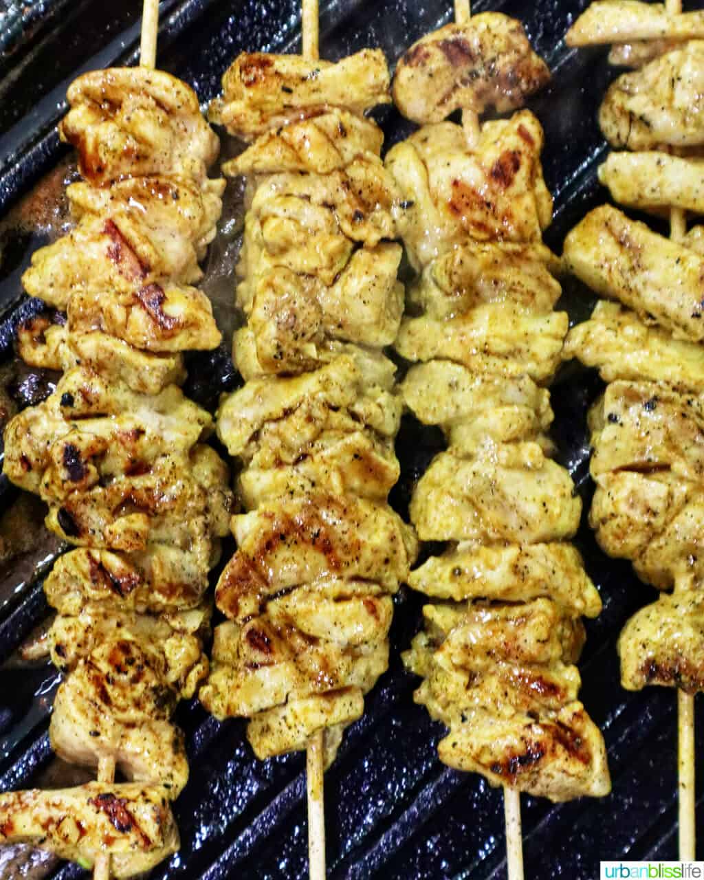 grilling tandoori chicken skewers.