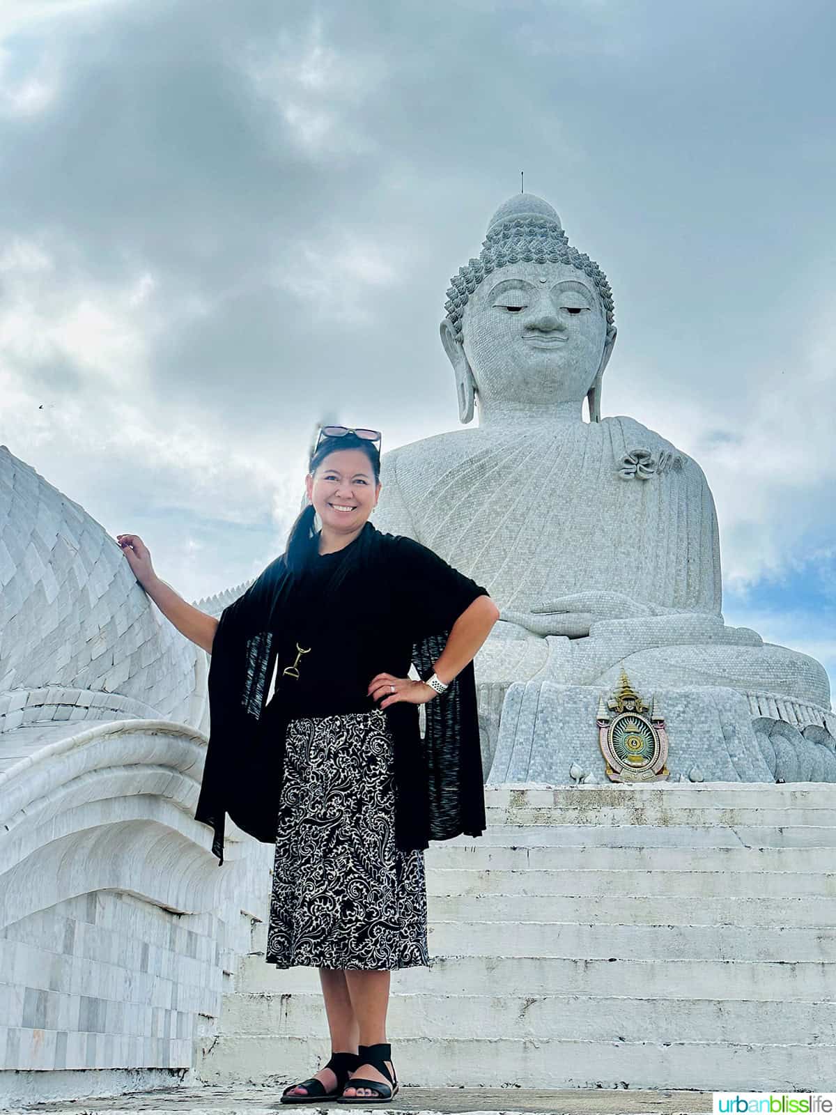 Marlynn Jayme Schotland standing on the steps in front of the Big Buddha in Phuket, Thailand.