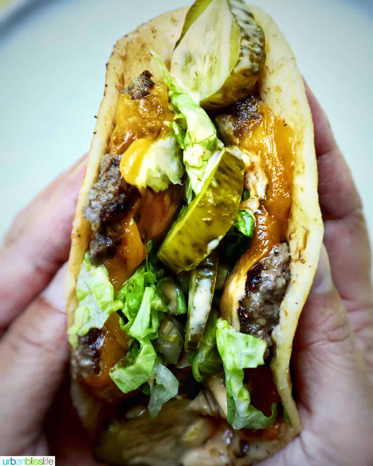 hands holding Big Mac Smash Tacos