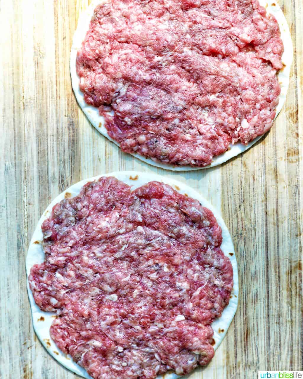 two smash burgers on taco tortillas.