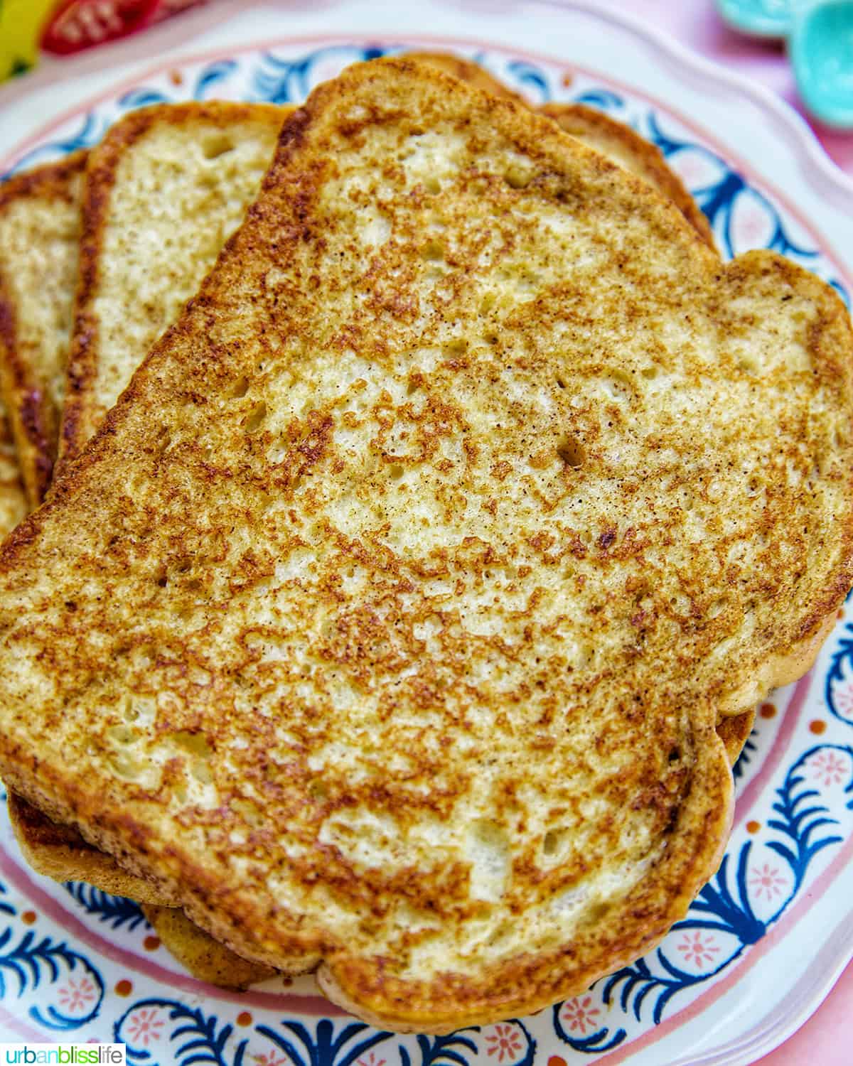 stack of high protein french toast on a colorful plate.