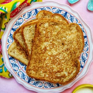 stack of high protein french toast on a colorful plate.