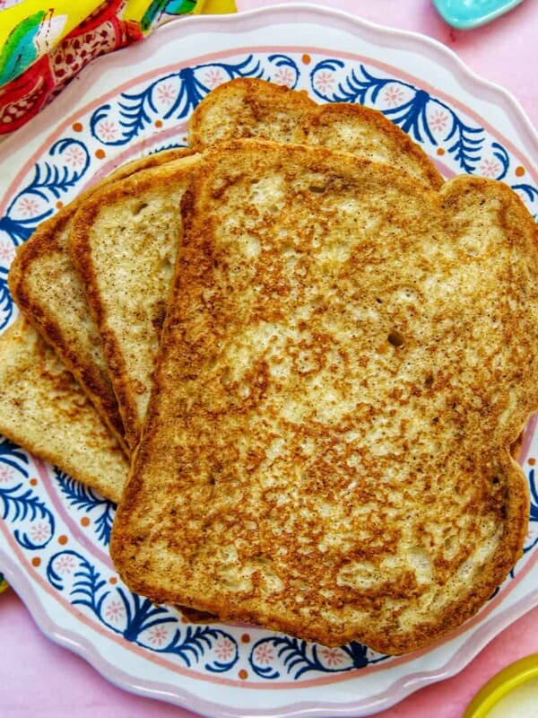 stack of high protein french toast on a colorful plate.