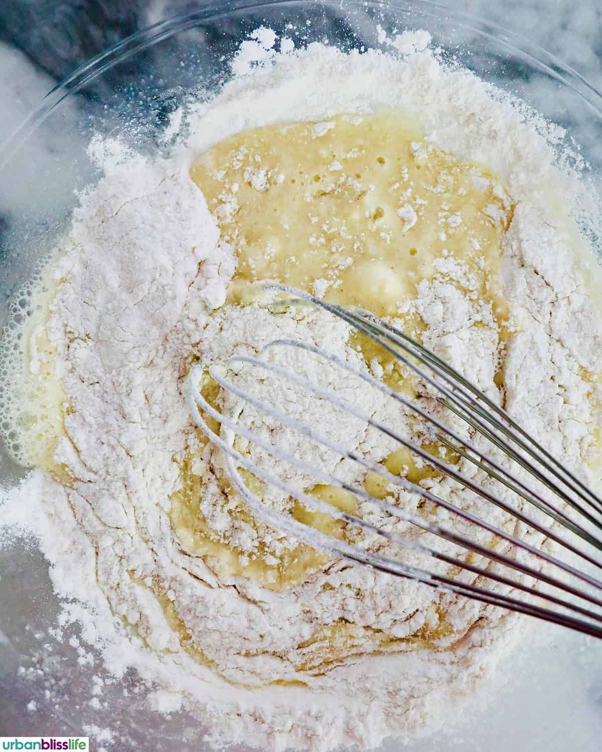 muffin batter with whisk in a bowl.