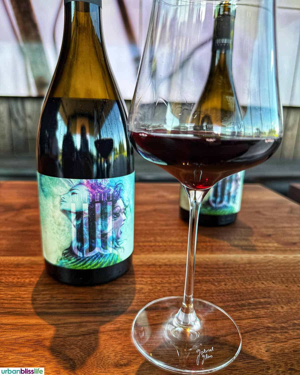 bottle and glass of LucidWild Fusion pinot noir