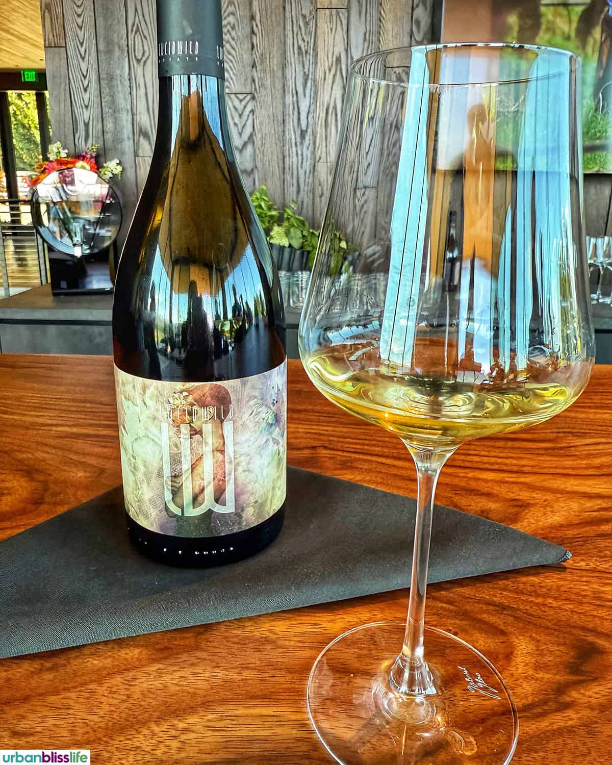 bottle and glass of LucidWild Hidden Chardonnay