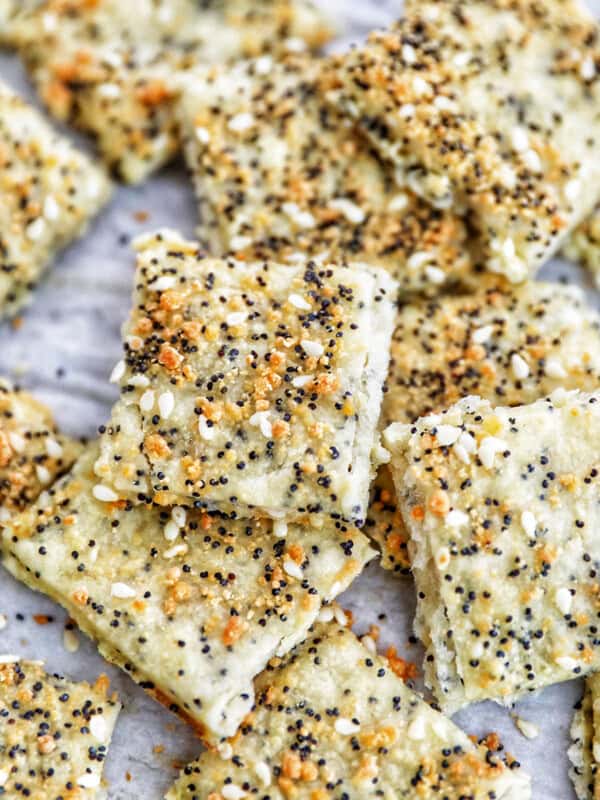 several sesame crackers laid out on a baking sheet.