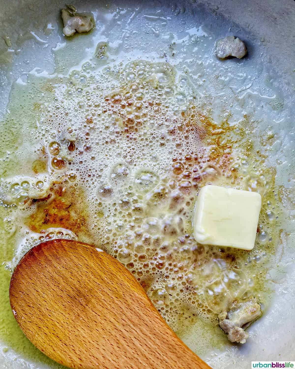 wooden spoon in pan with butter.