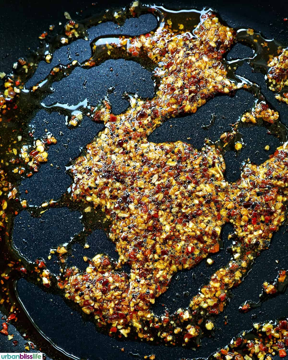 chili crisp and oil in a pan.