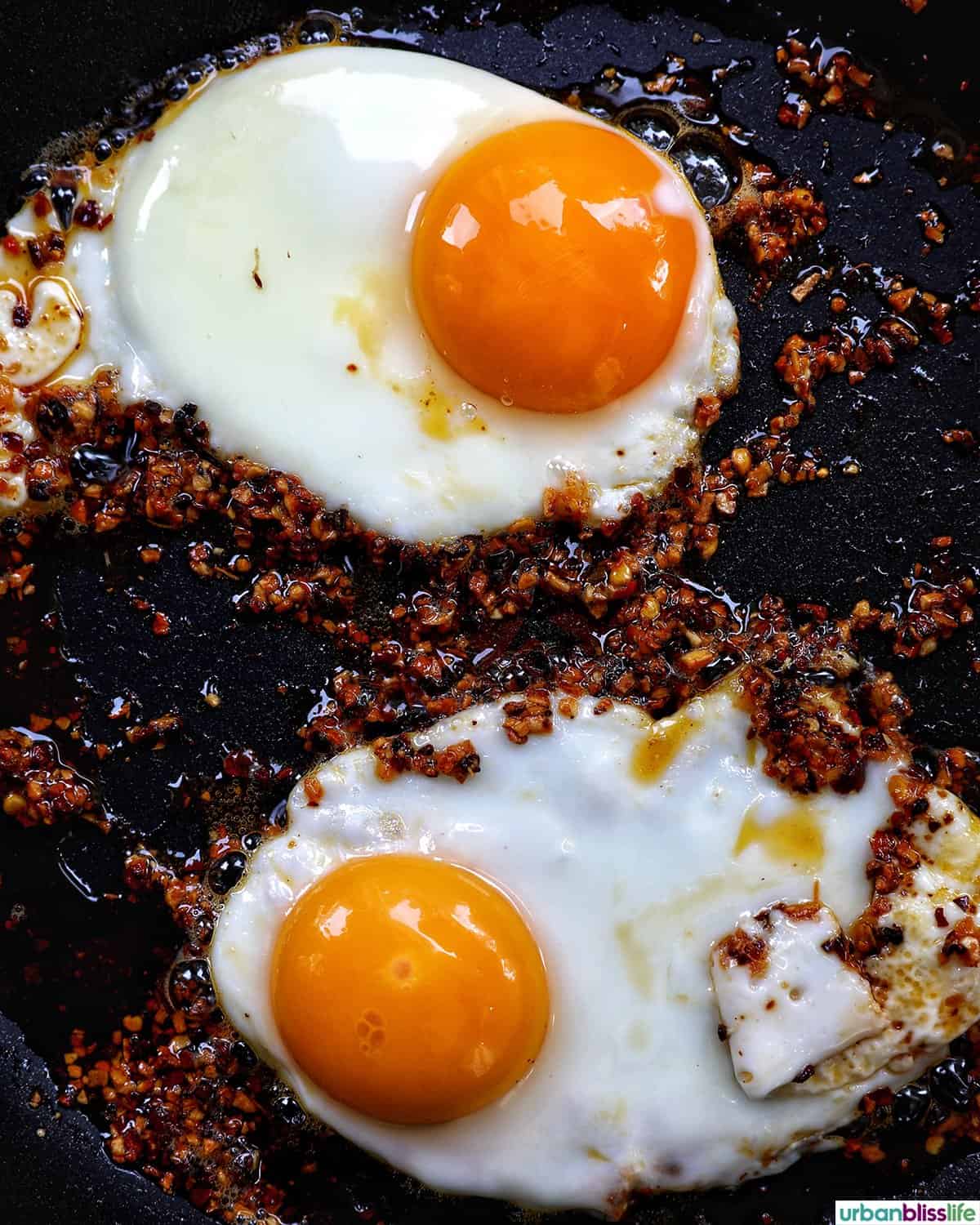 chili crisp eggs in a pan.