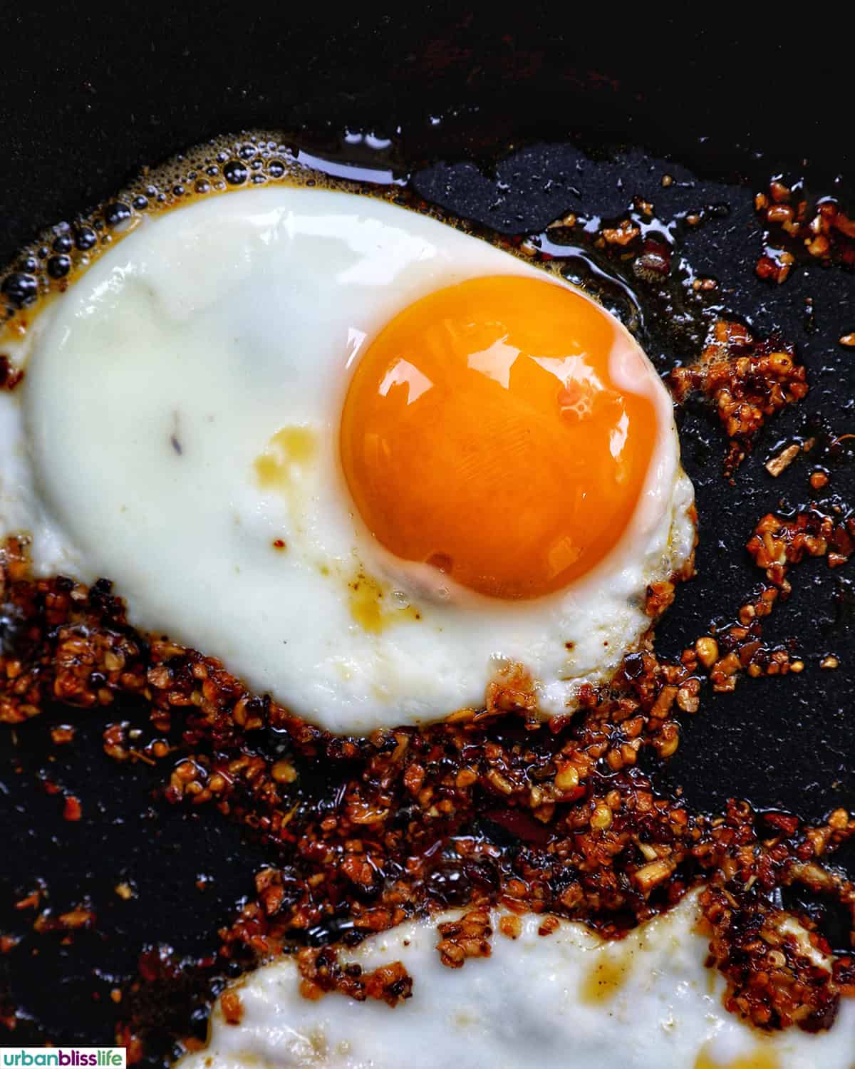 chili crisp egg and oil in a pan.