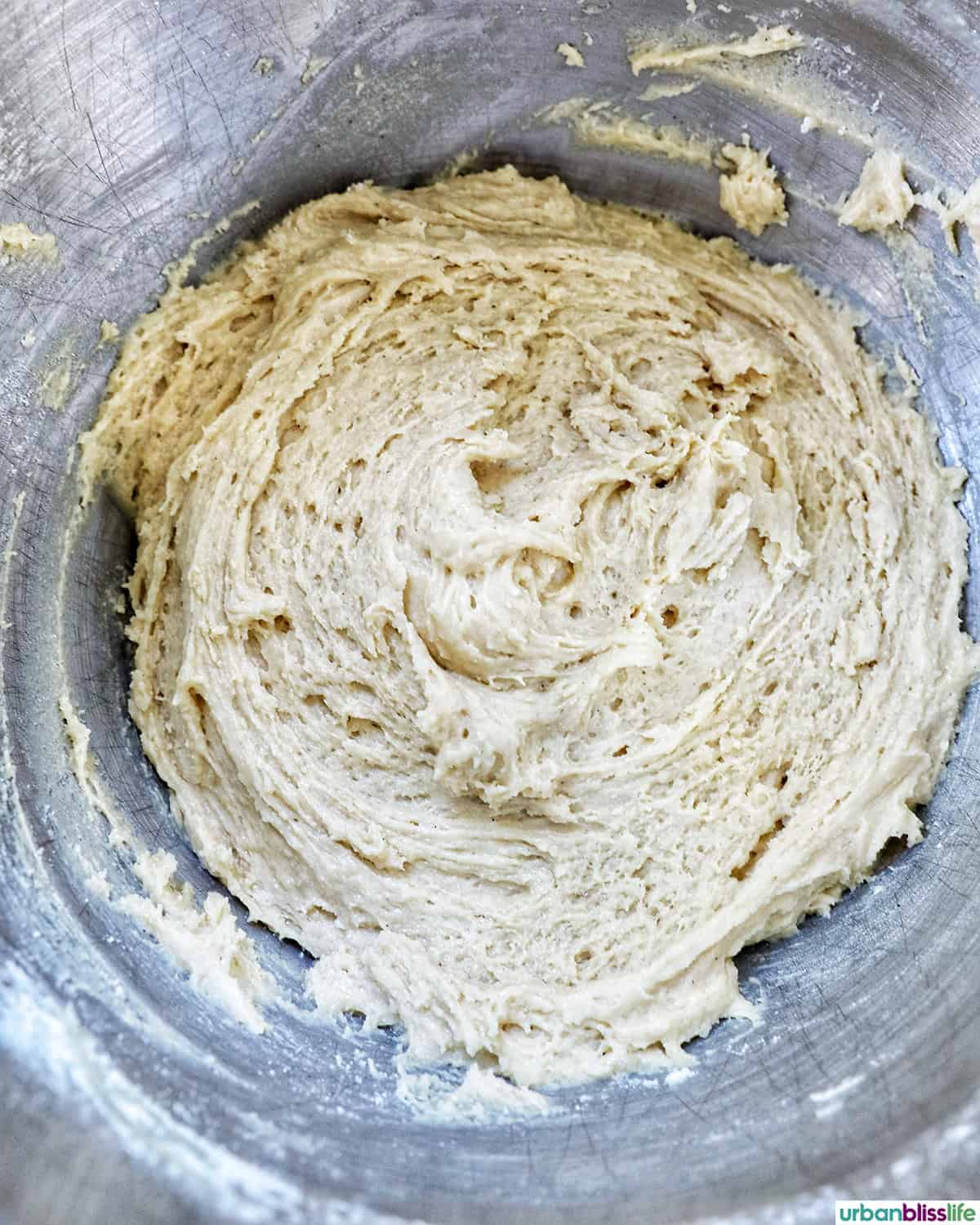 cookie batter in a stainless steel mixing bowl.