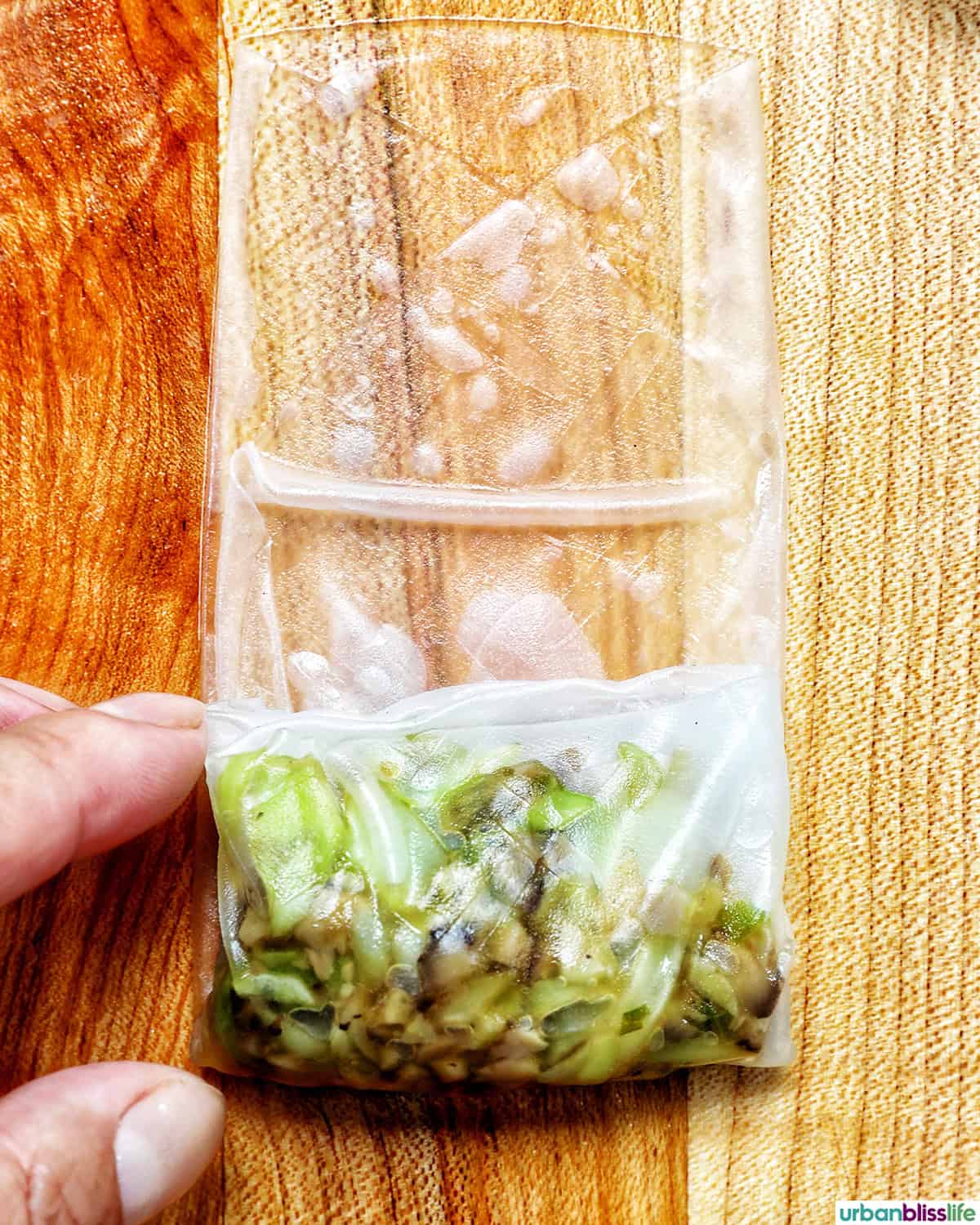 vegetable filling on top of a rice paper wrapper being folded.