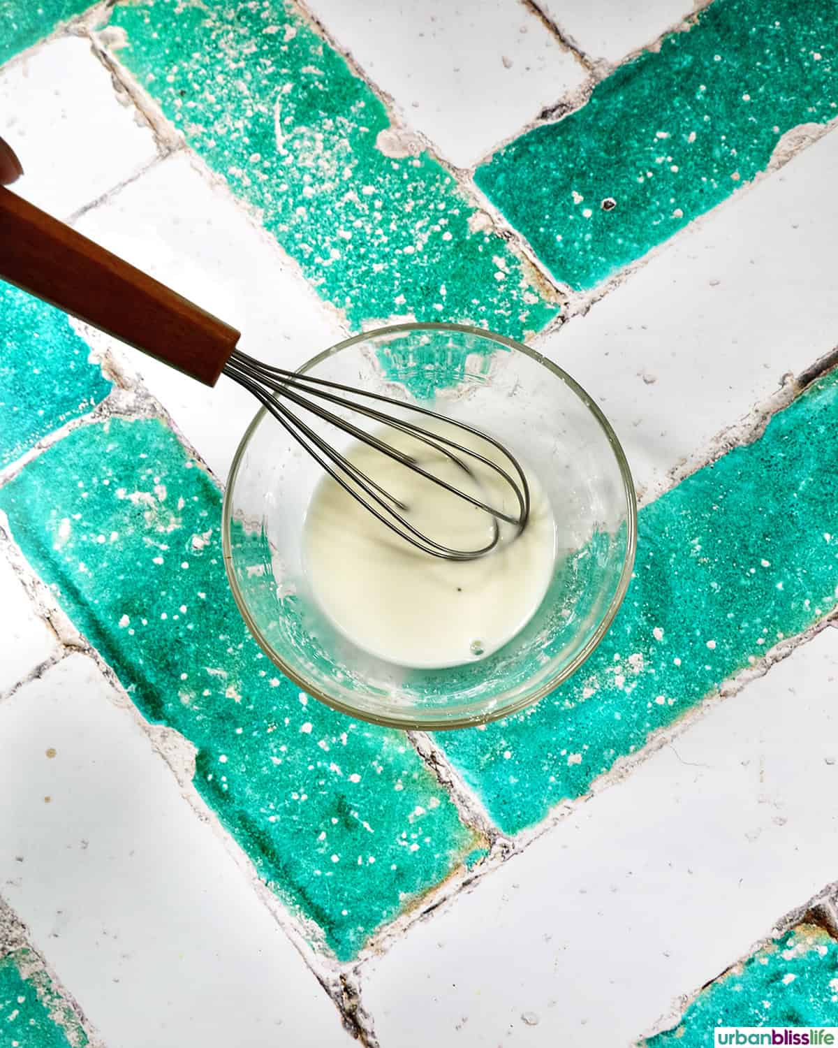 cornstarch slurry in a bowl with a whisk.