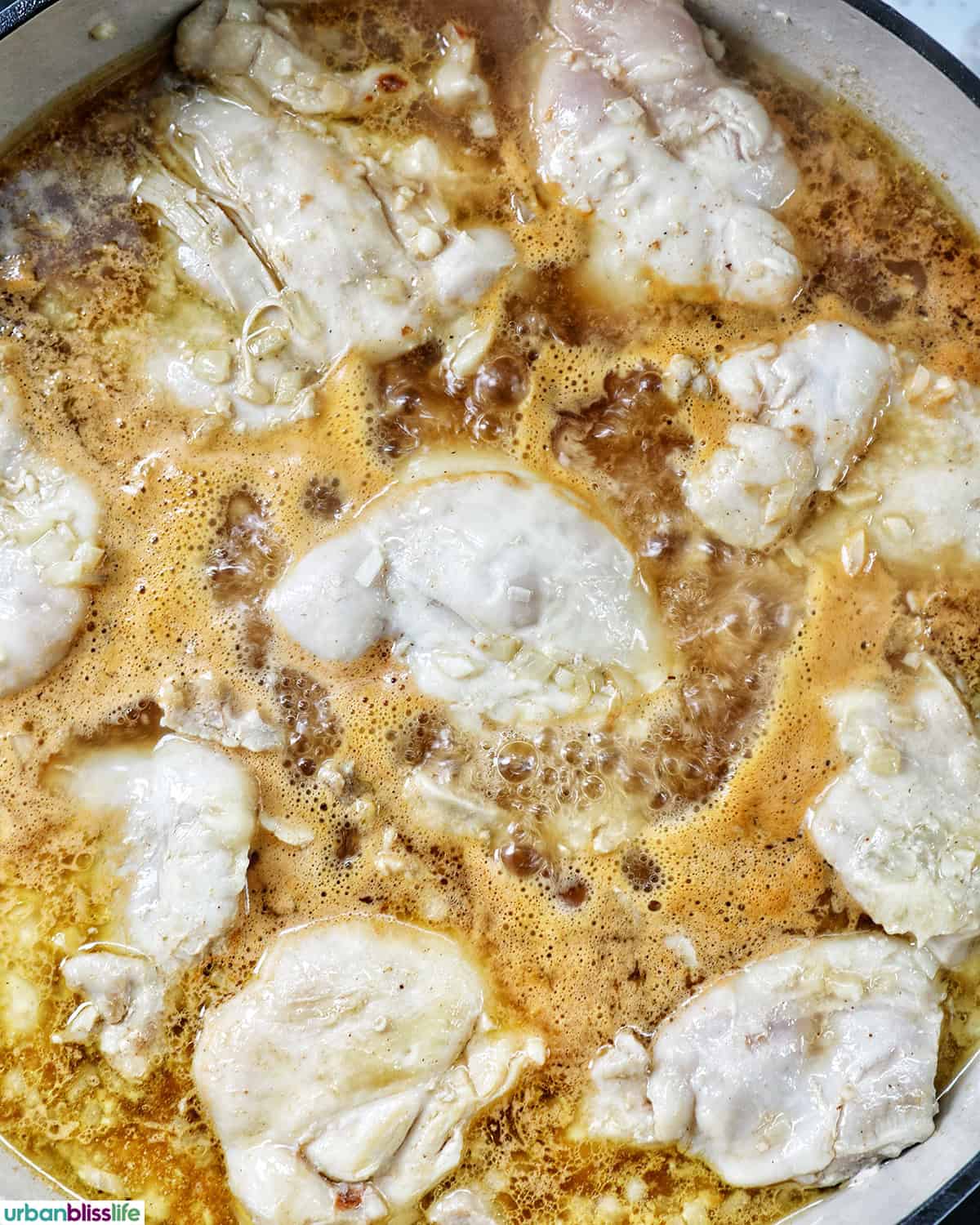 chicken cooking in sauce.