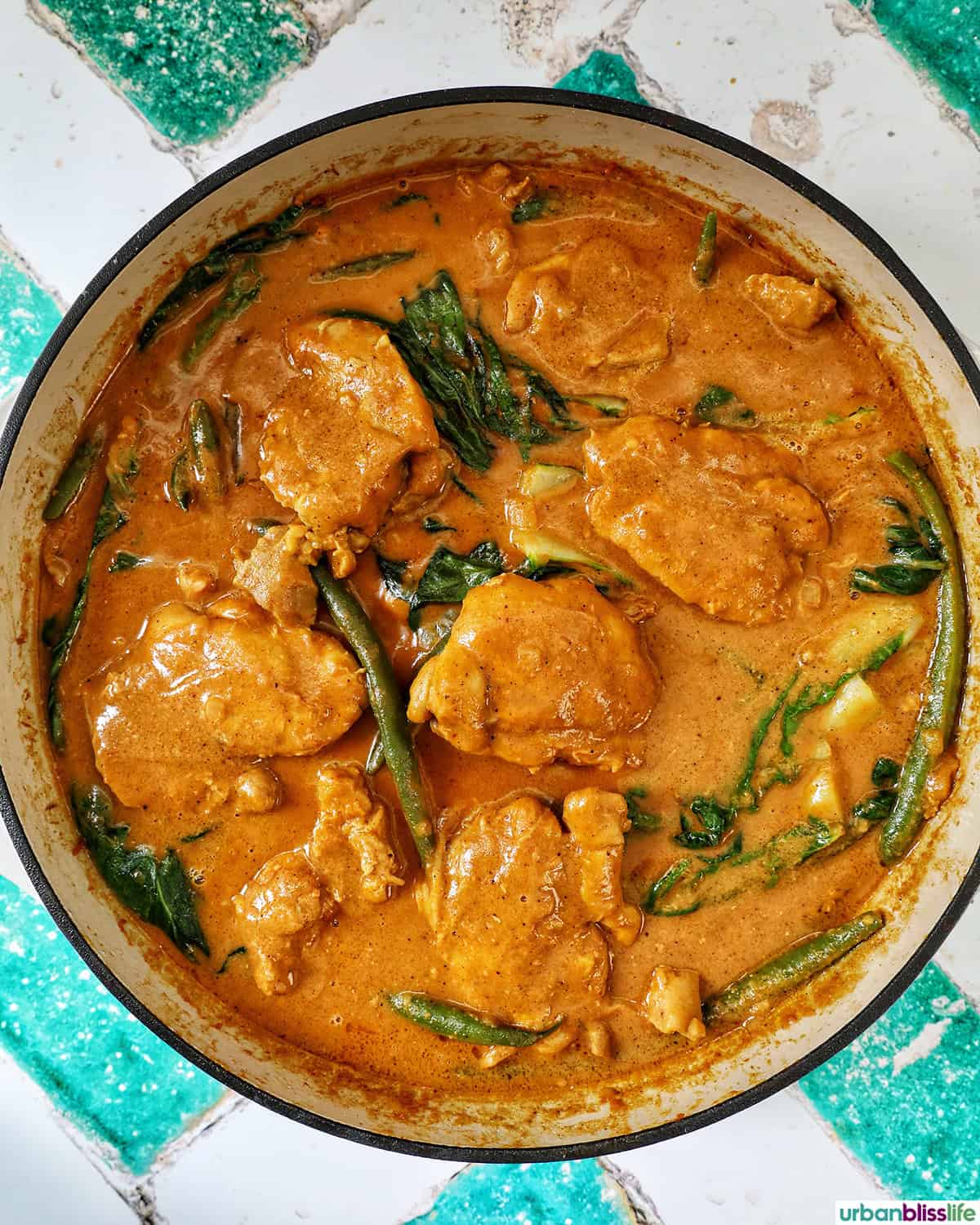 Filipino chicken kare kare in a pan.