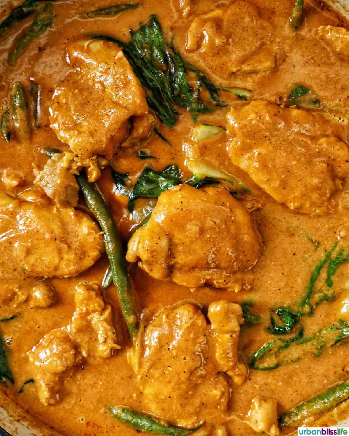 Filipino chicken kare kare in a pan.