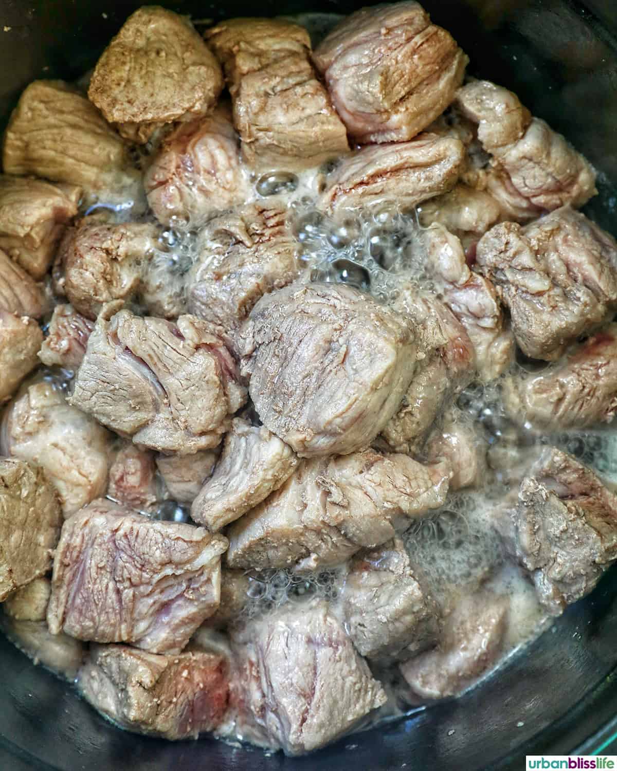pork cooking in a pot.