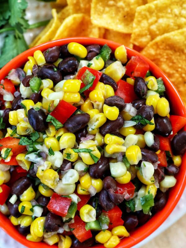 bowl of black bean corn dip with side of chips.
