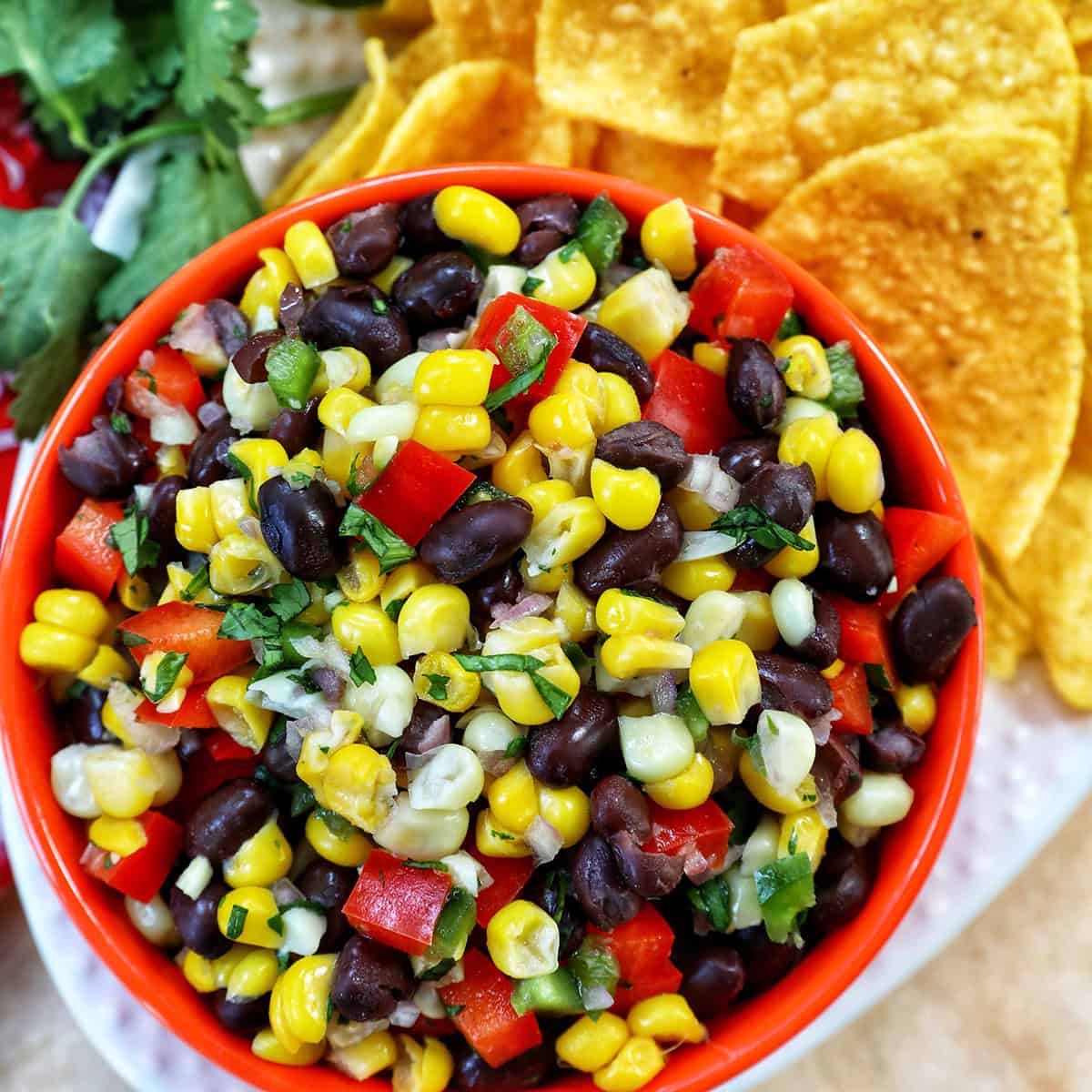 bowl of black bean corn dip with side of chips.