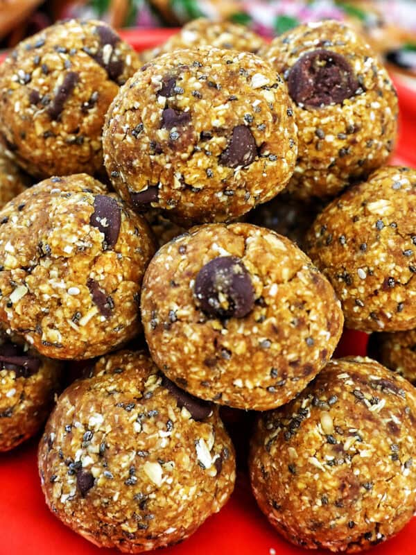 stack of pumpkin protein balls on an orange plate.