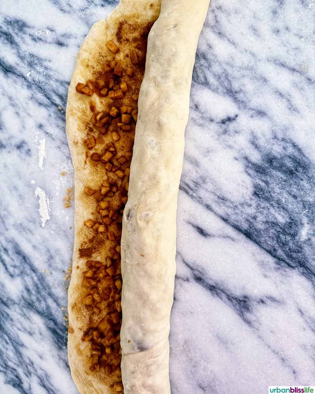 apple pie cinnamon roll dough rolled up.