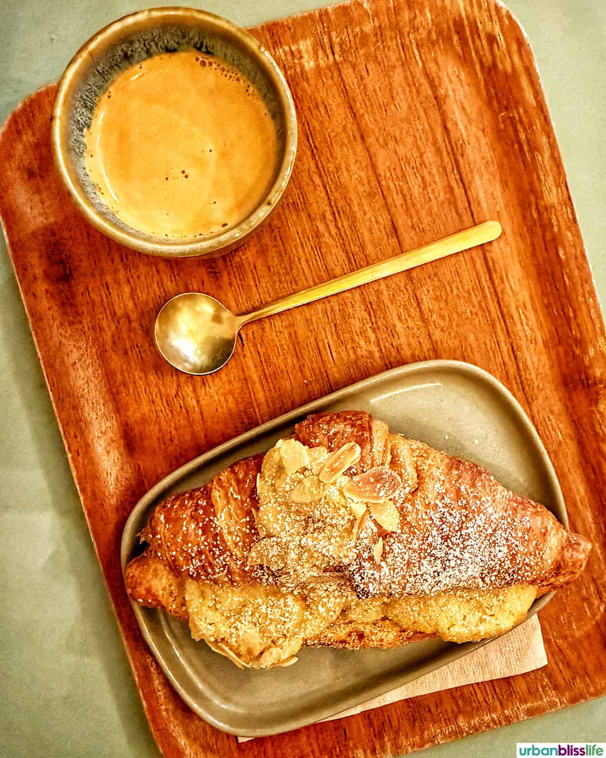 espresso and an almond croissant at boulangerie Michel MaBelle in Bordeaux, France.