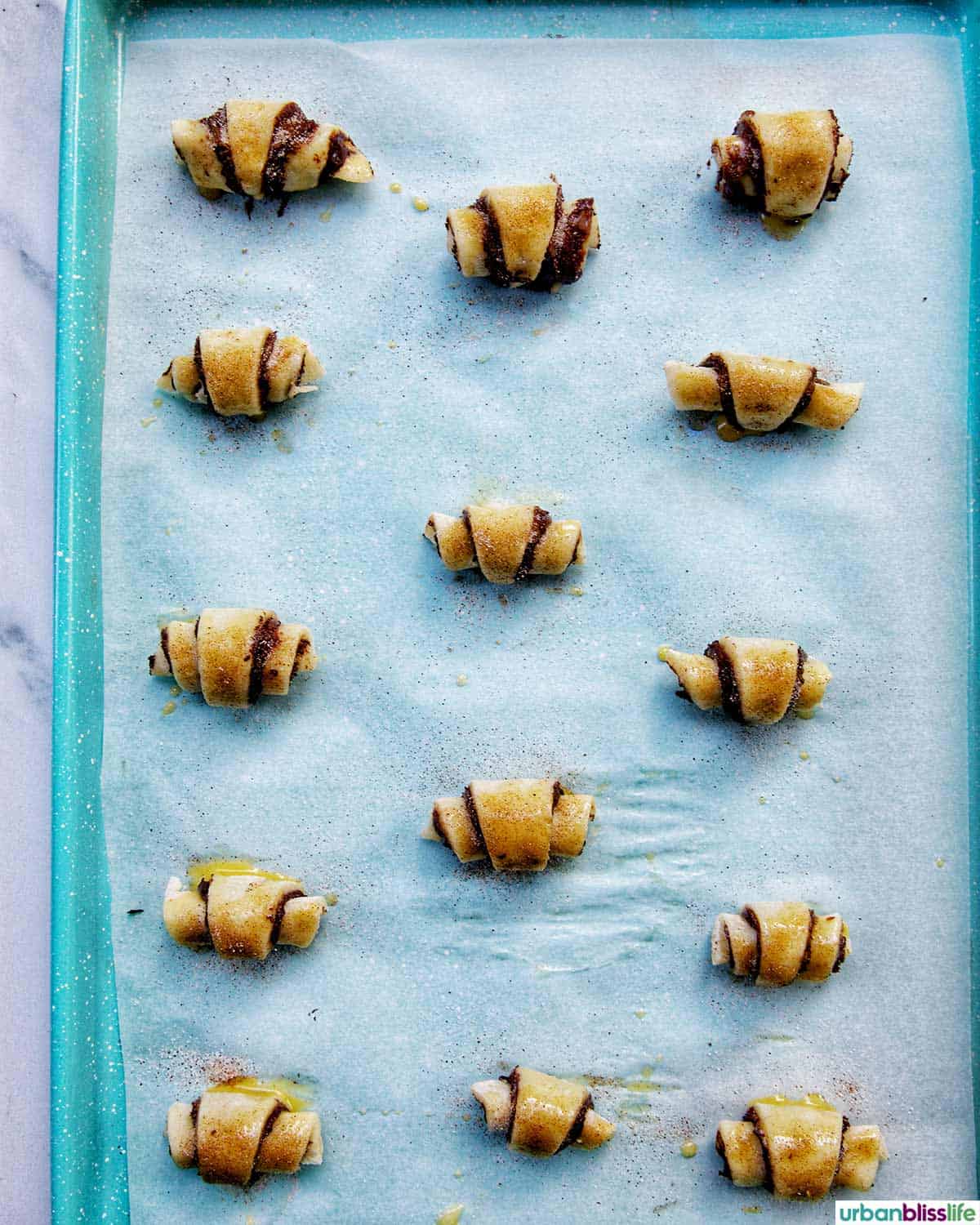 chocolate rugelach on baking sheet.