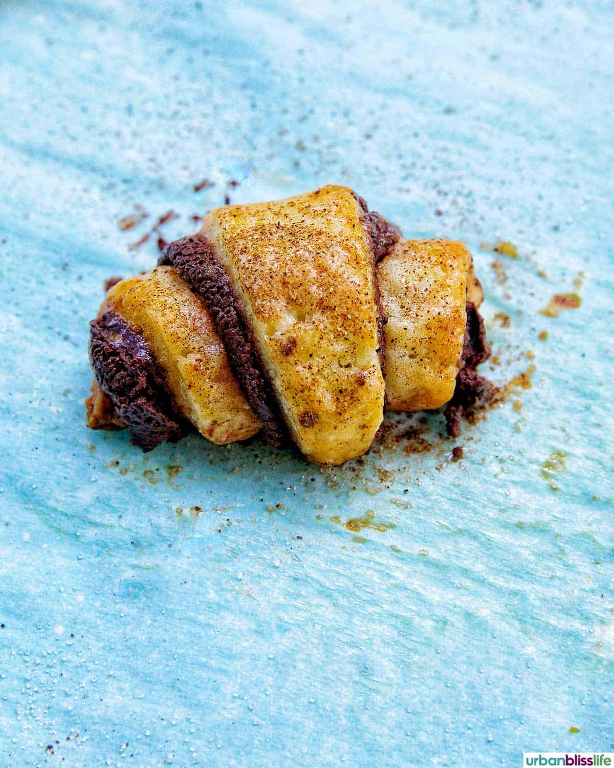 chocolate rugelach on a baking sheet.