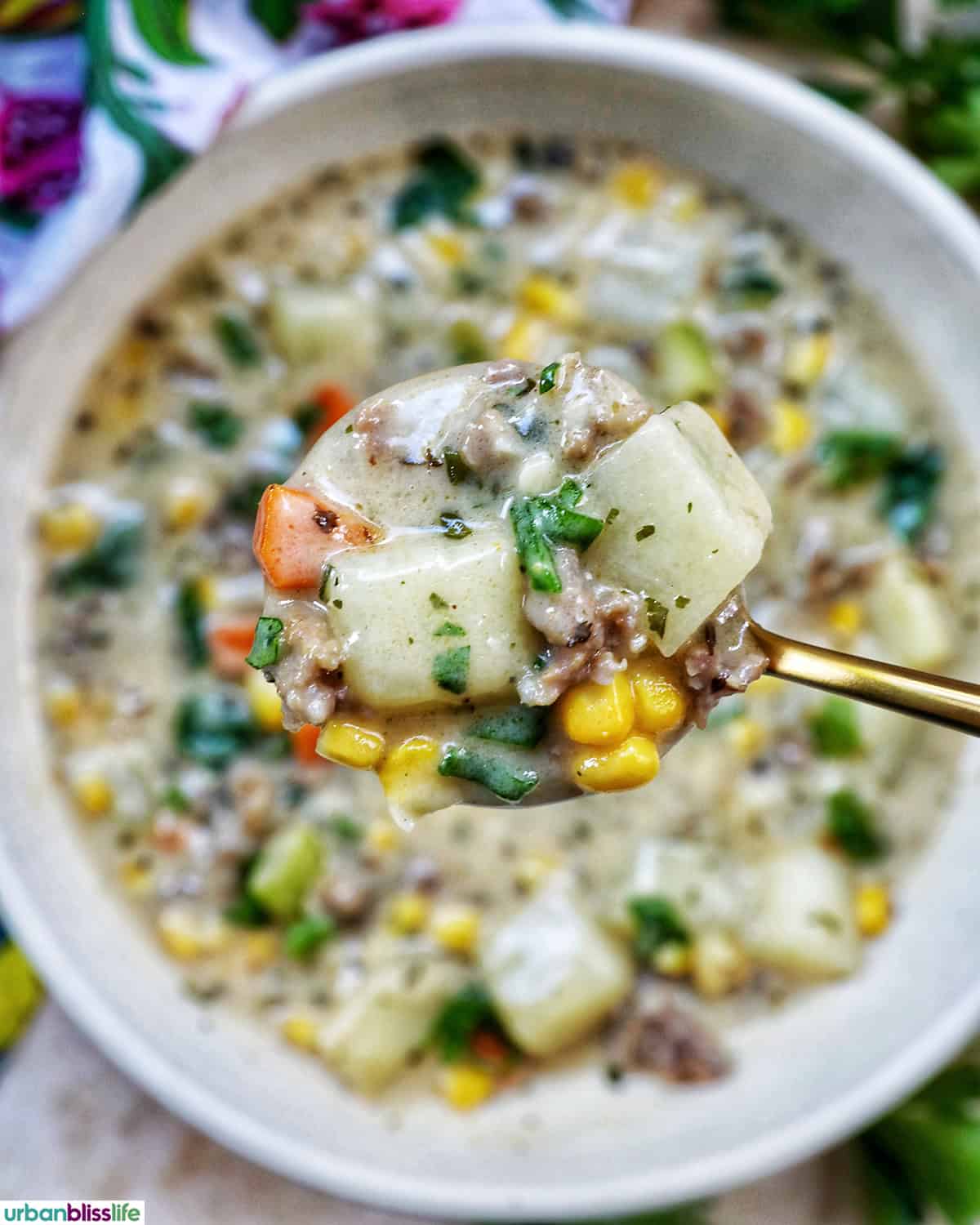 spoonful of bowl of corn and sausage chowder.