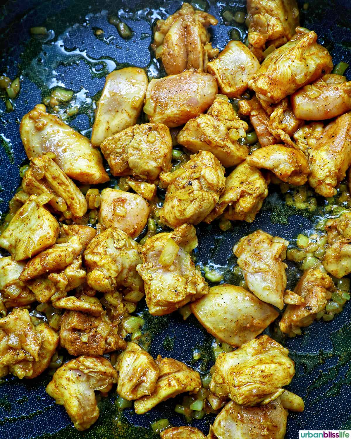 chicken cooking in a pan.