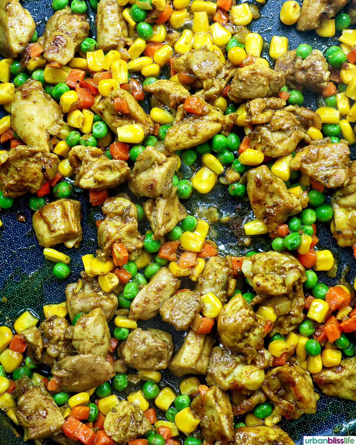 curry chicken fried rice in a pan.