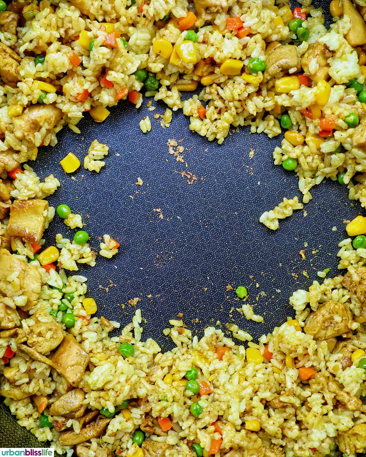curry chicken fried rice in a pan.