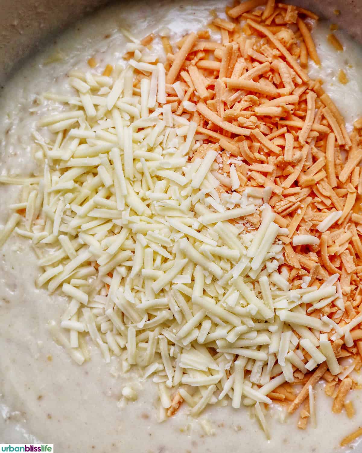 shredded cheeses melting in a pan.