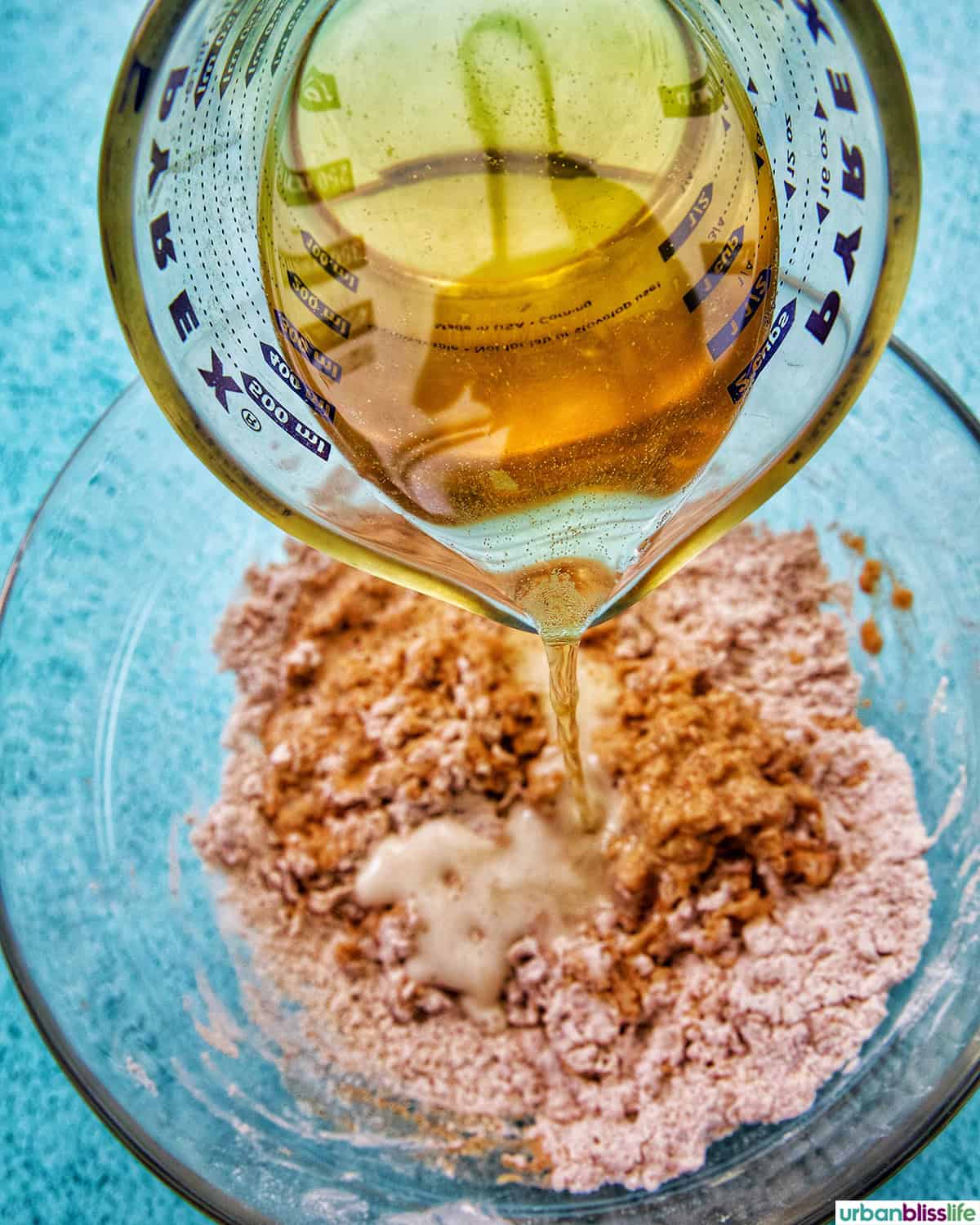 adding beer to batter for shrimp.