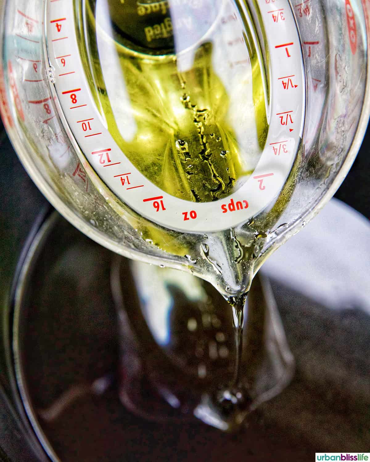pouring cooking oil into a Dutch oven.