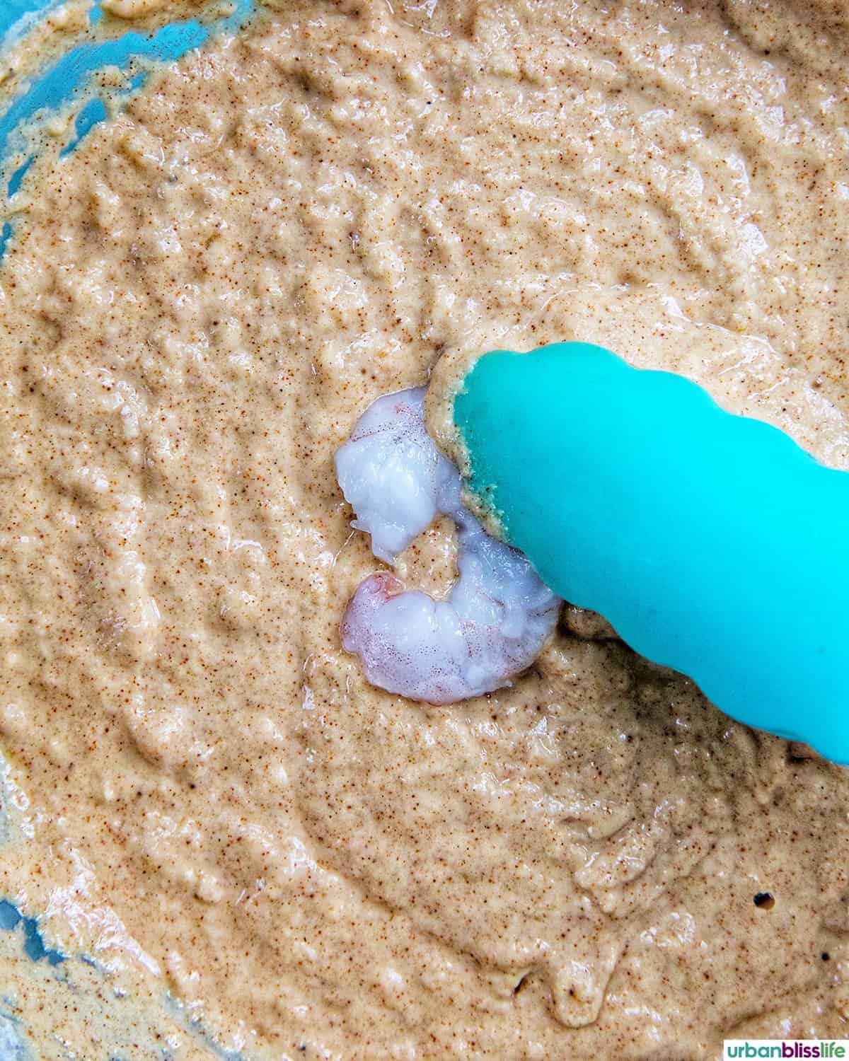 dredging shrimp into beer batter.