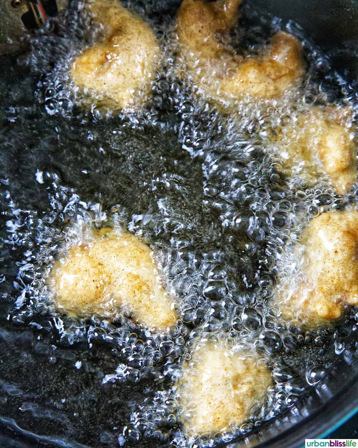 beer battered shrimp frying in oil.