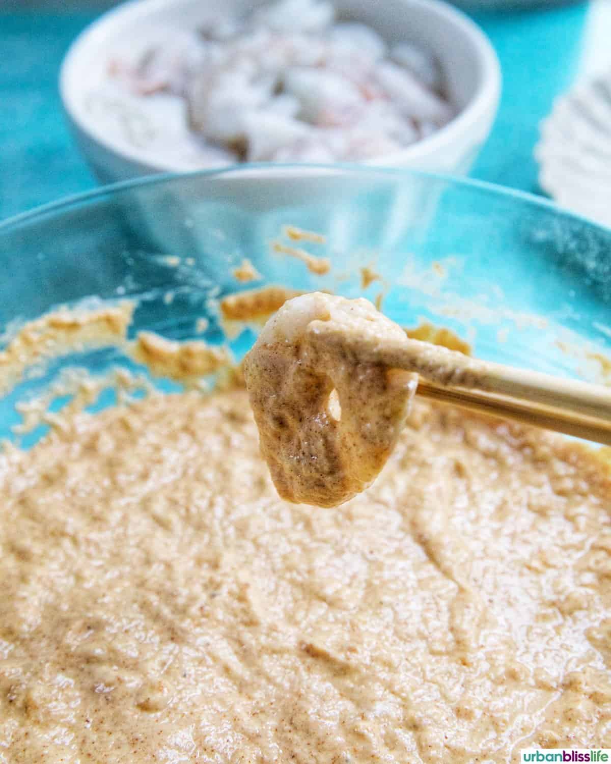 dredging shrimp into beer batter.