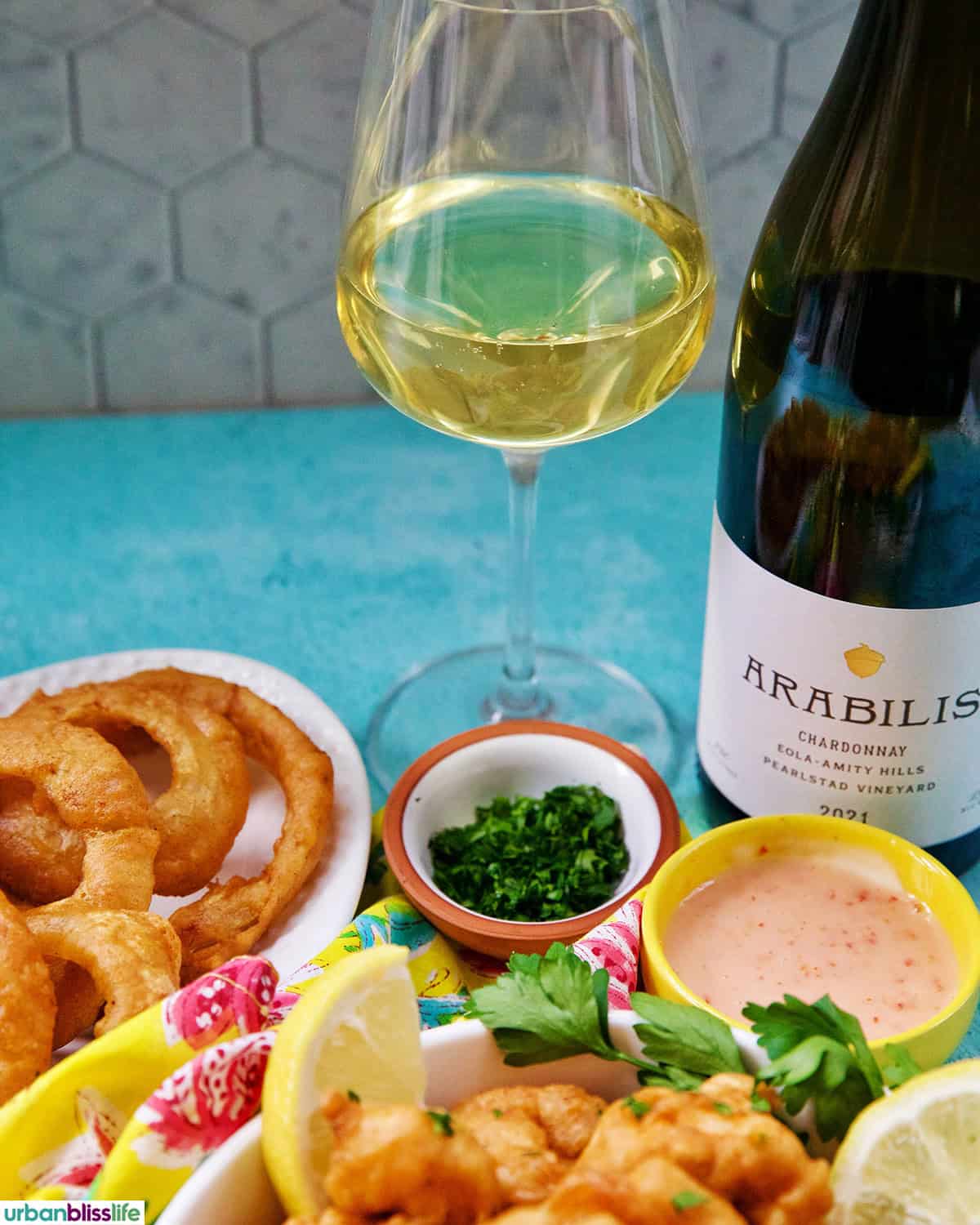 bottle and glass of white wine with This beer battered shrimp.