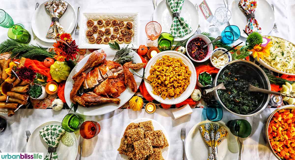 Friendsgiving Thanksgiving table with turkey on a table with mini pecan pies and butternut squash mac and cheese.