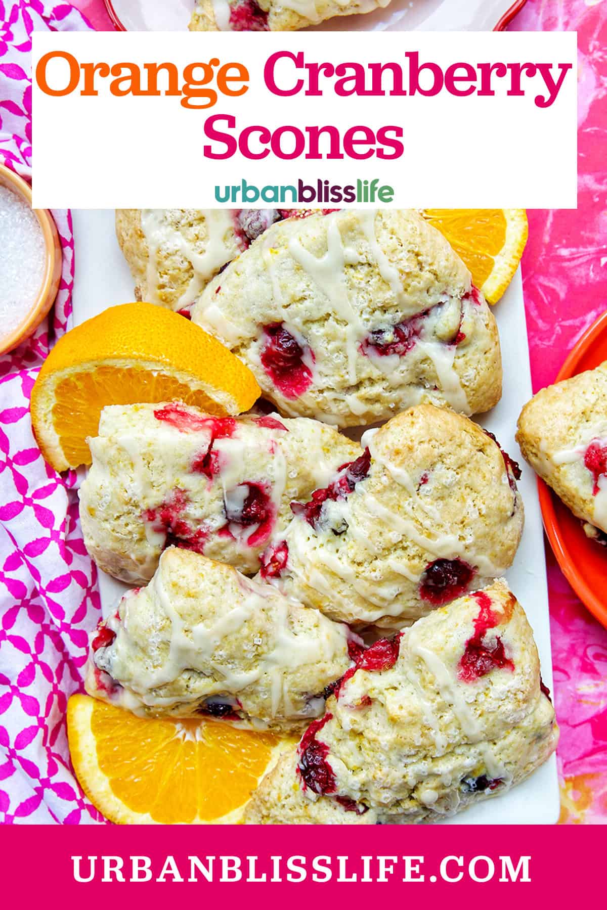 orange cranberry scones with orange slices on a plate with title text overlay.