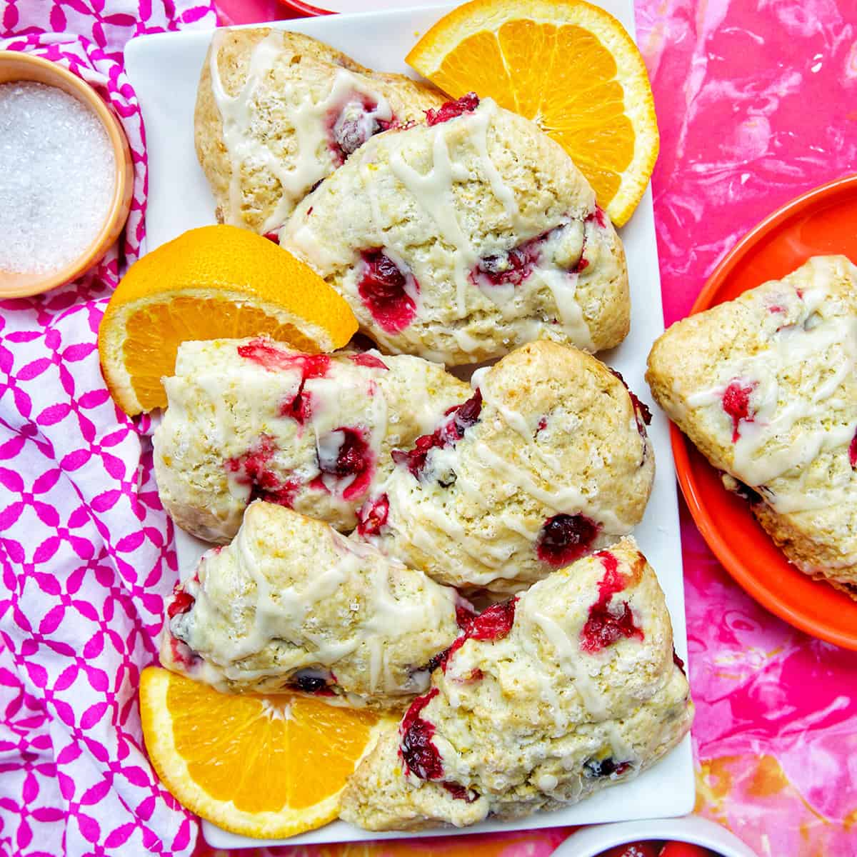 These orange cranberry scones are perfect for breakfast, brunch, or afternoon tea. Bright, buttery, and bursting with cranberries & citrus. Get the easy pastry recipe at UrbanBlissLife.com.