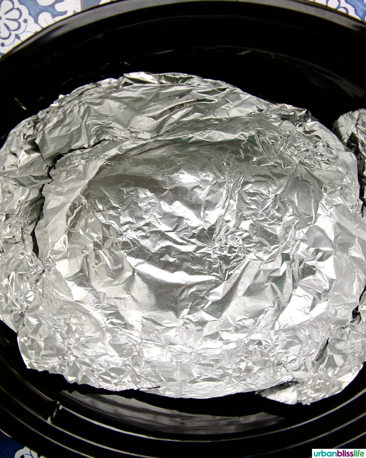 aluminum foil lining a crockpot.