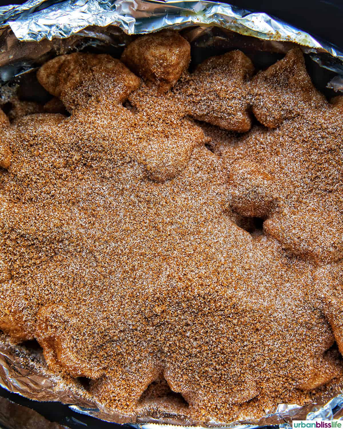 cinnamon sugar over slow cooker monkey bread in the crockpot.