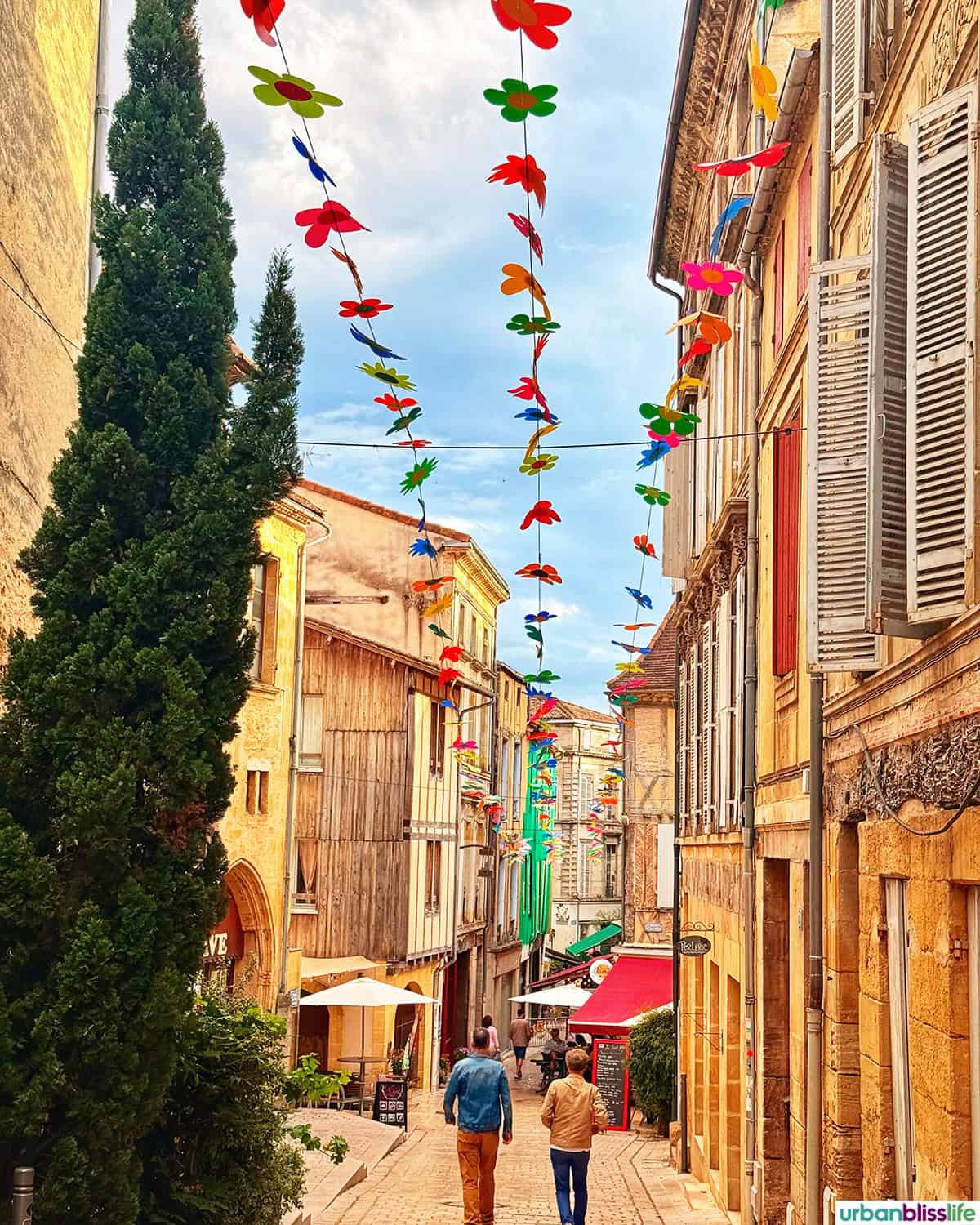 bergerac france side street with colorful flags