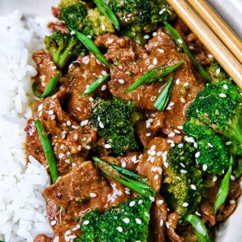 slow cooker beef and broccoli with white rice in a bowl.