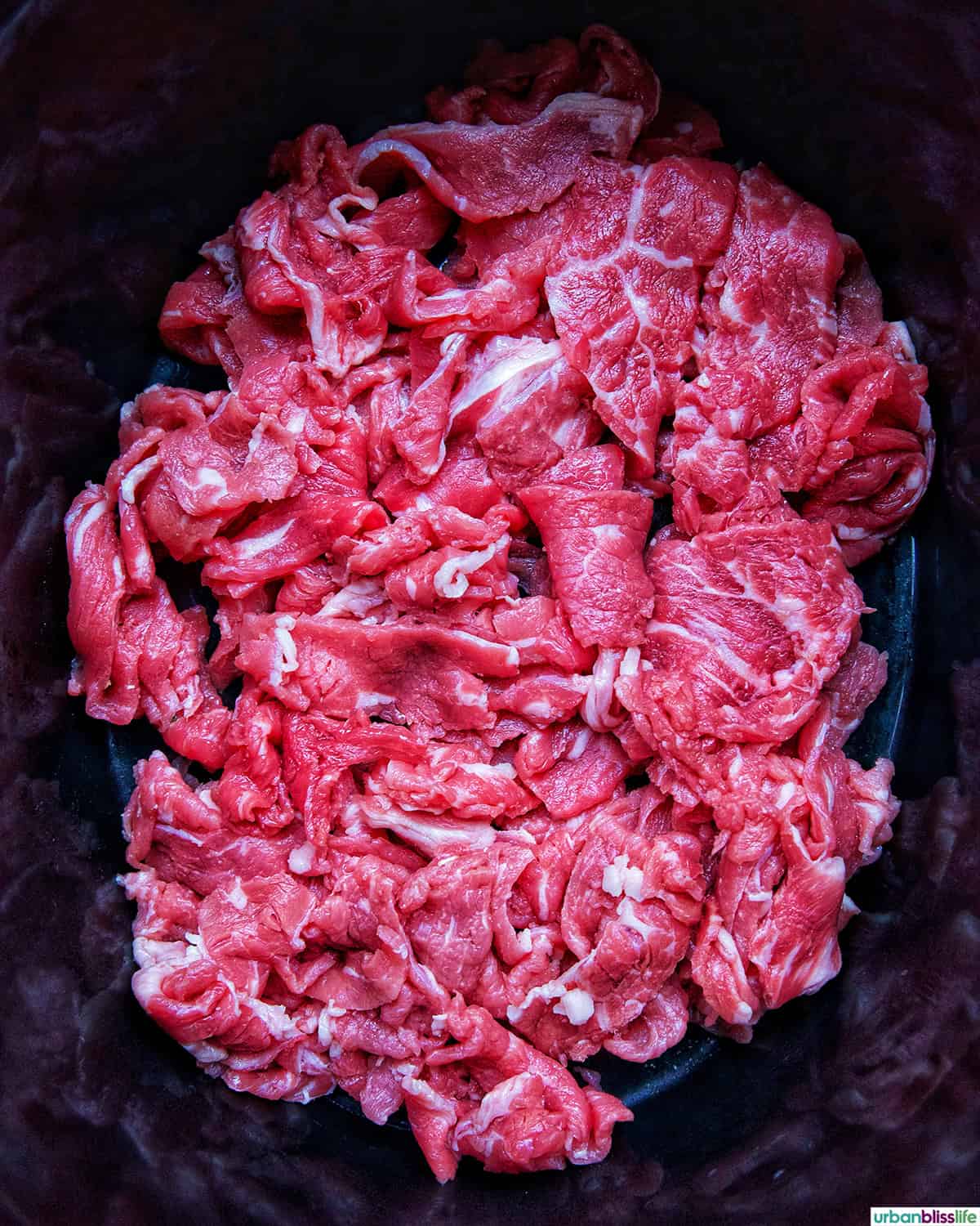 sliced beef in a Dutch oven.