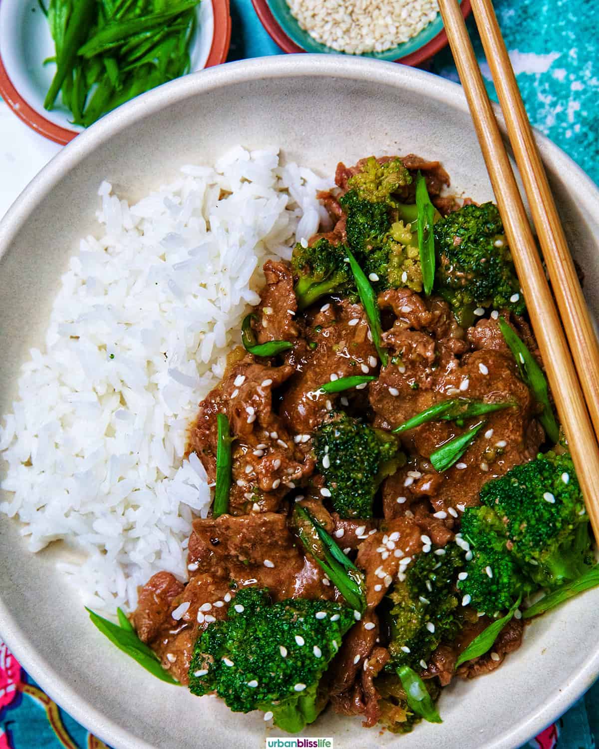 slow cooker beef and broccoli with white rice in a bowl.