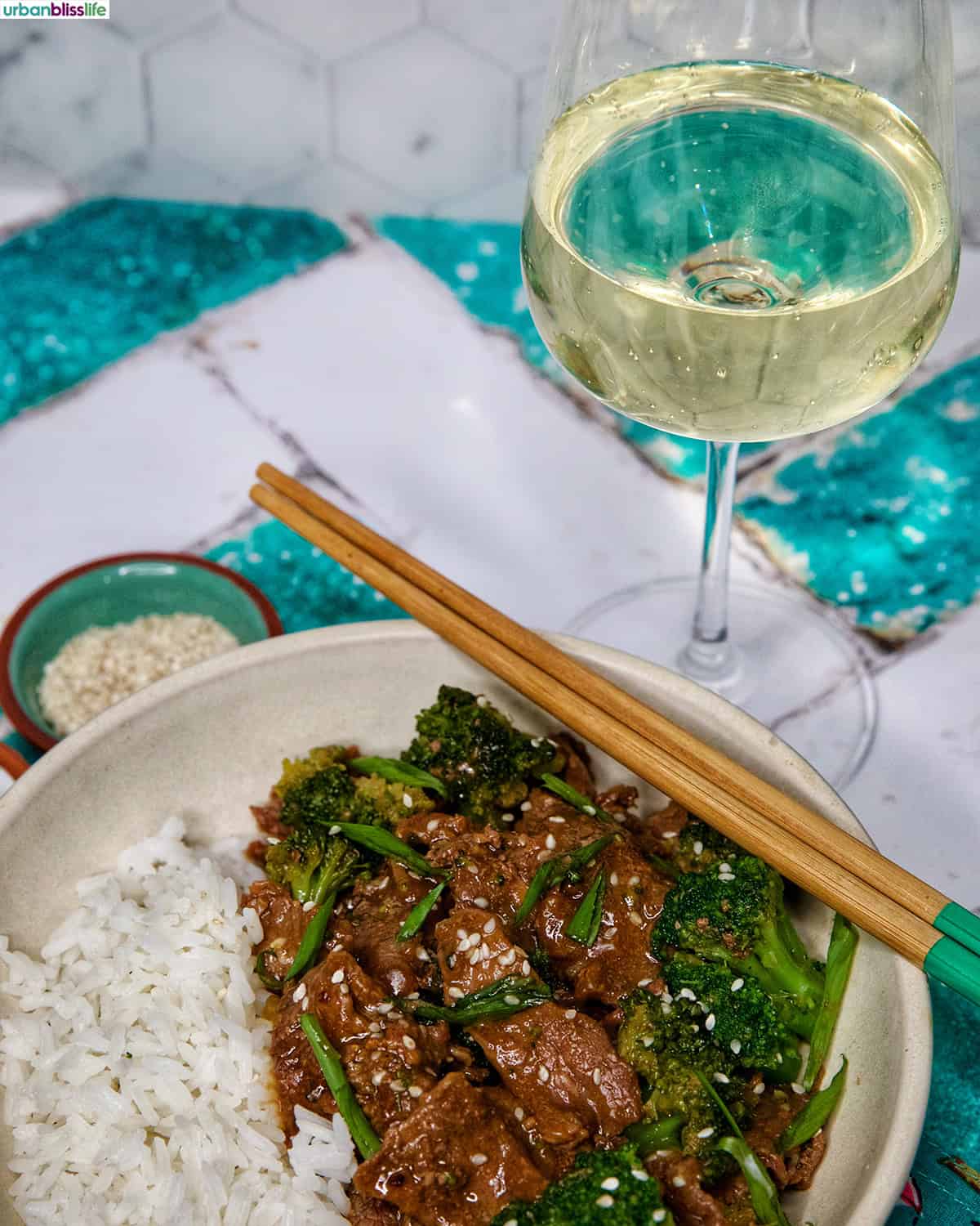 glass of white wine with slow cooker beef and broccoli.